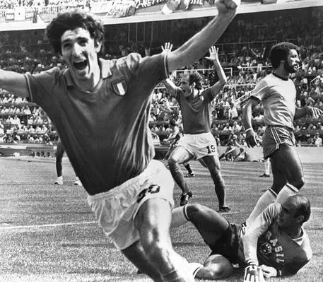 FILE - In this July 5, 1982 file photo, Italy's Paolo Rossi, left, celebrates, after scoring the second goal for his team during their World Cup match second round soccer match against Brazil, in Barcelona, Spain. Brazilian goalkeeper Valdir Perez, lies on pitch as defender Junior runs at right. The best players in the world go elsewhere. The best coaches in Italy emigrate. The stadiums around the country are falling apart. The lingering problems affecting Italy's domestic league might just be the reason for the country's failure to qualify for next year's World Cup.(ANSA/AP Photo/File) [CopyrightNotice: Copyright 2017 The Associated Press. All rights reserved.]