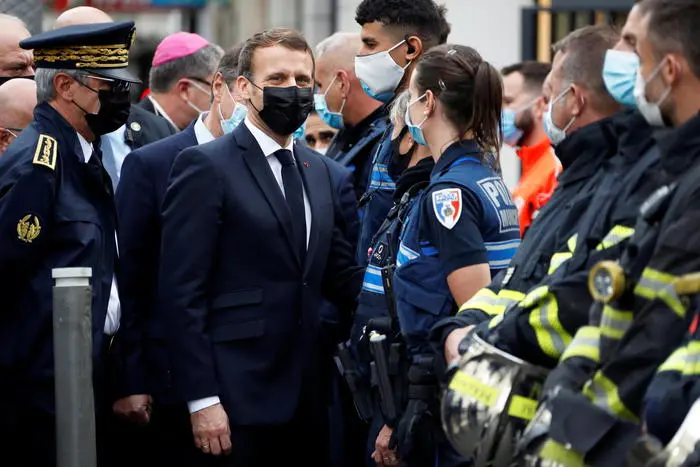 epa08783062 French President Emmanuel Macron (C) visits the scene of a reported knife attack at Notre Dame church in Nice, France, 29 October 2020. According to recent reports, at least three people are reported to have died in what officials treat as a terror attack. The attack comes less than a month after the beheading of a French middle school teacher in Paris on 16 October. EPA/ERIC GAILLARD / POOL MAXPPP OUT