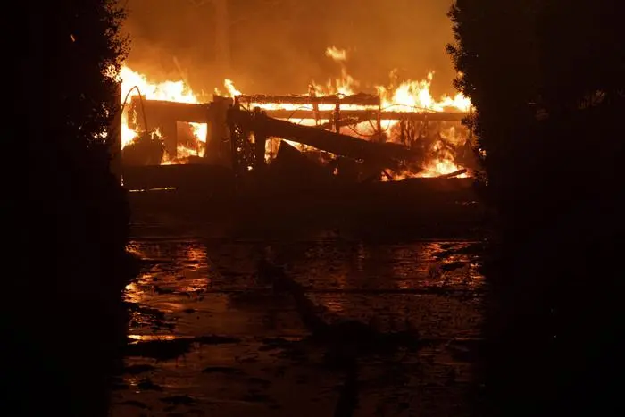 A house burns to the ground on Jolette Way in Granada Hills North, Calif., early Friday morning, Oct. 11, 2019. The fast wind-driven wildfire spread rapidly from Sylmar to Porter Ranch late Thursday and early Friday destroying multiple homes. (David Crane/The Orange County Register via AP) [CopyrightNotice: Los Angeles Daily News/SCNG]