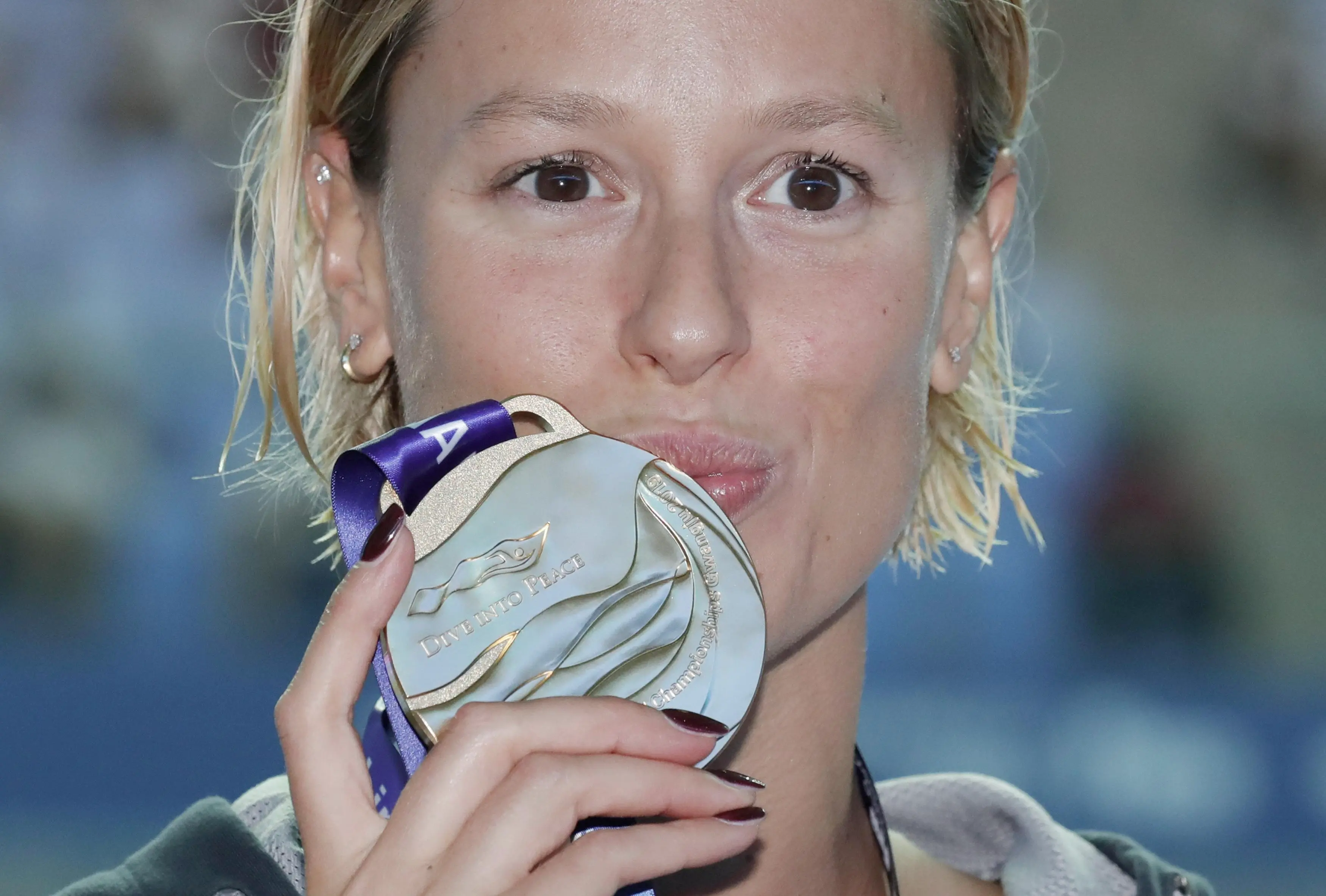 Gold medalist Italy's Federica Pellegrini, kisses her medal following the women's 200m freestyle final at the World Swimming Championships in Gwangju, South Korea, Wednesday, July 24, 2019. (ANSA/AP Photo/Lee Jin-man) [CopyrightNotice: Copyright 2018 The Associated Press. All rights reserved]