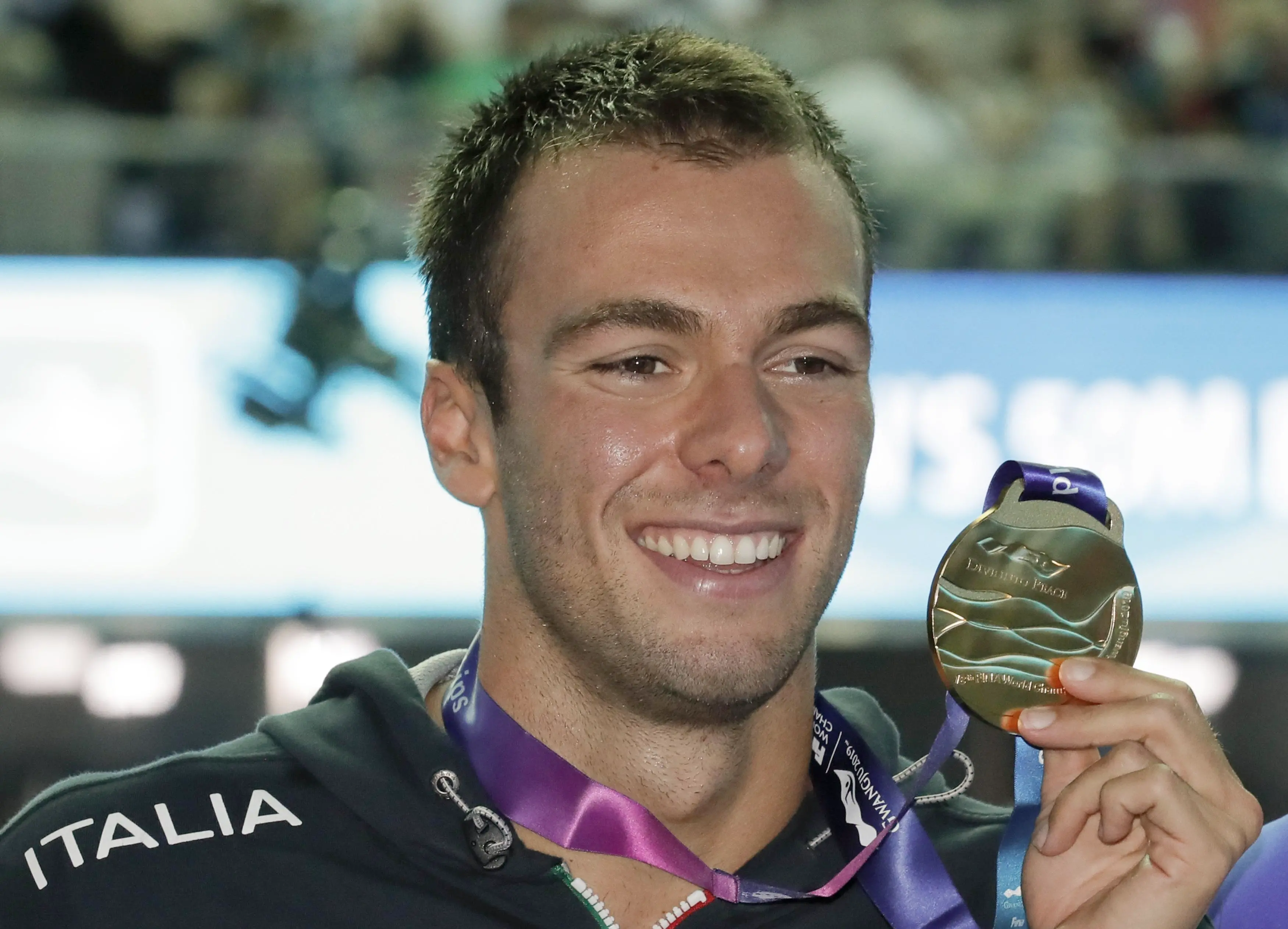 Gold medalist Italy's Gregorio Paltrinieri poses with his medal following the men's 800m freestyle final at the World Swimming Championships in Gwangju, South Korea, Wednesday, July 24, 2019. (ANSA/AP Photo/Lee Jin-man) [CopyrightNotice: Copyright 2018 The Associated Press. All rights reserved]