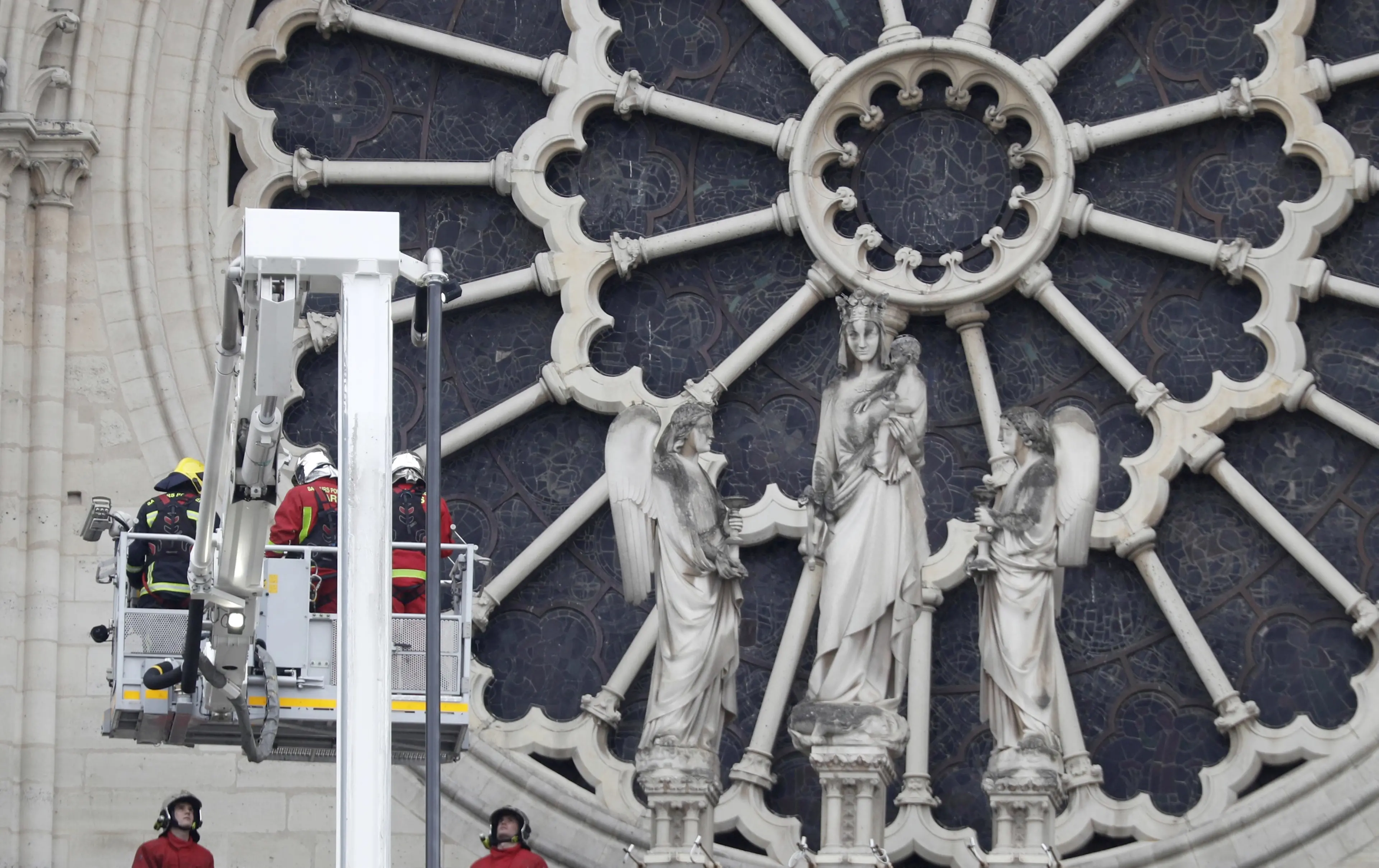 Firefighters work near the rose window of Notre Dame cathedral Tuesday April 16, 2019, following the devastating fire Monday night in Paris. Experts are assessing the blackened shell of Paris' iconic Notre Dame Cathedral to ascertain what artifacts can be saved and what has been lost in the blaze. (ANSA/AP Photo/Thibault Camus) [CopyrightNotice: Copyright 2019 The Associated Press. All rights reserved.]