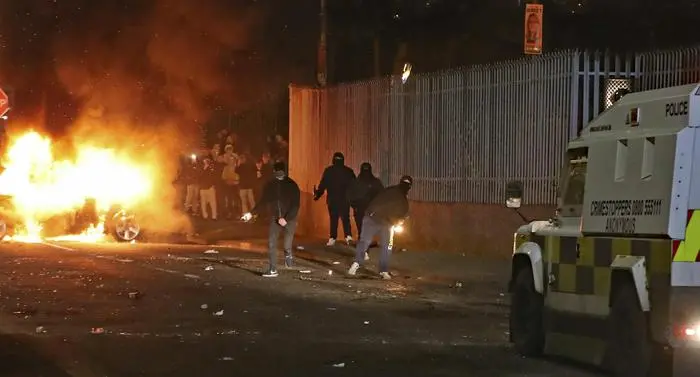 Petrol bombs are thrown at police in Creggan, Londonderry, in Northern Ireland, Thursday, April 18, 2019. (Niall Carson/PA via AP)