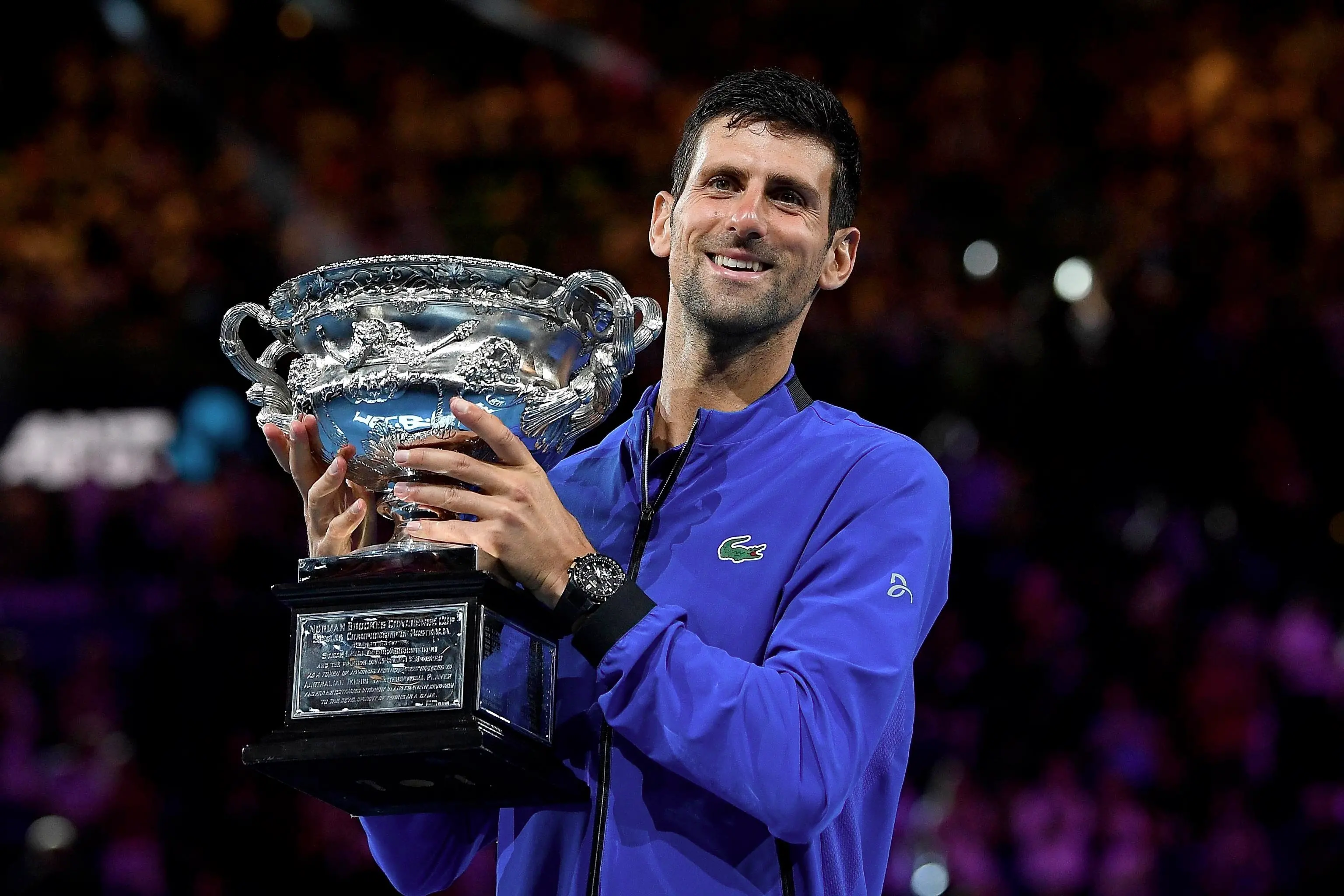 epa07324081 Novak Djokovic of Serbia raises the trophy after winning his men's singles final match against Rafael Nadal of Spain at the Australian Open Grand Slam tennis tournament in Melbourne, Australia, 27 January 2019. EPA/JULIAN SMITH EDITORIAL USE ONLY AUSTRALIA AND NEW ZEALAND OUT