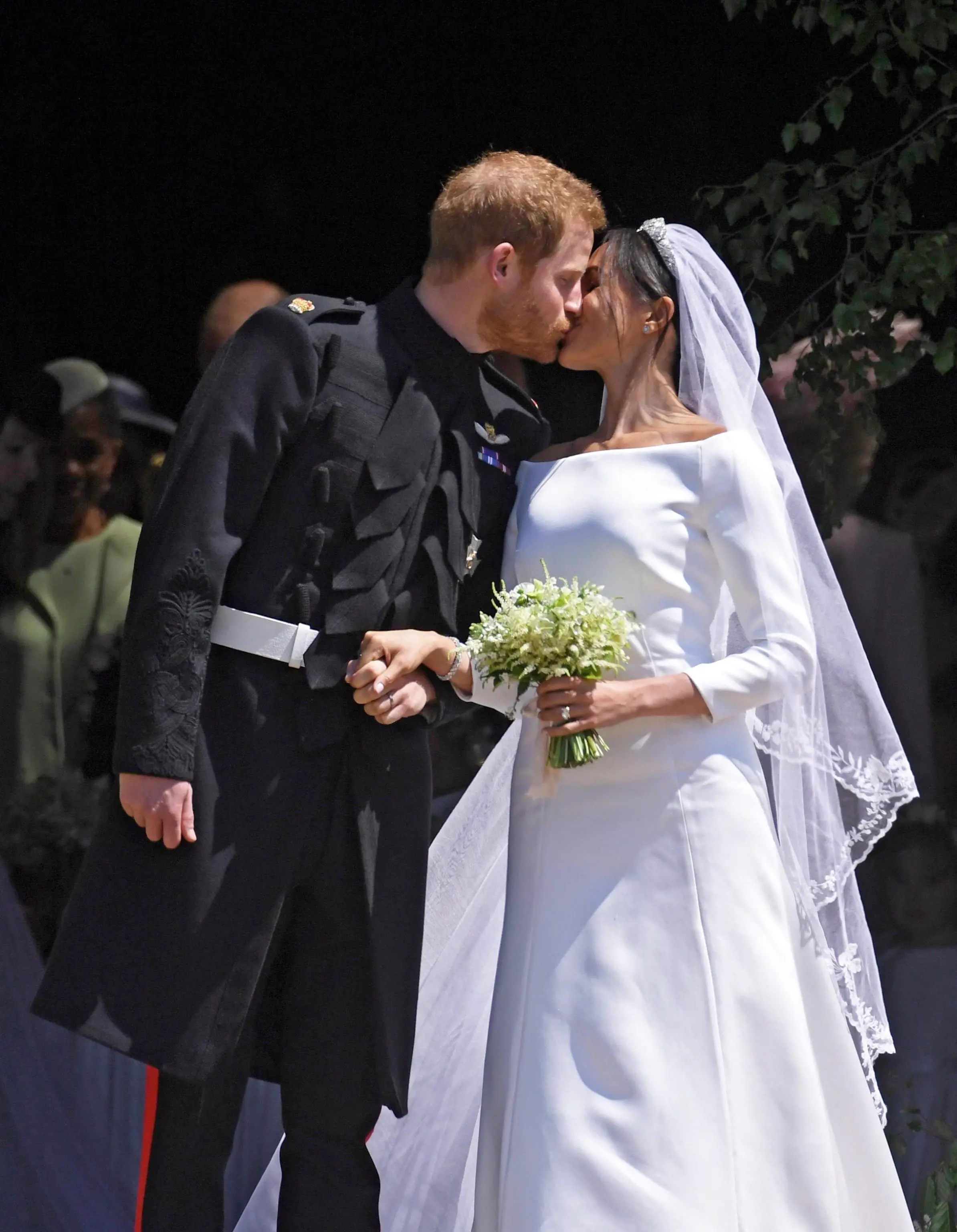 epa06749313 Britain's Prince Harry (L) and Meghan Markle (R) kiss as they exit St George's Chapel in Windsor Castle after their royal wedding ceremony, in Windsor, Britain, 19 May 2018. The couple have been bestowed the royal titles of Duke and Duchess of Sussex on them by the British monarch. EPA/NEIL HALL / POOL