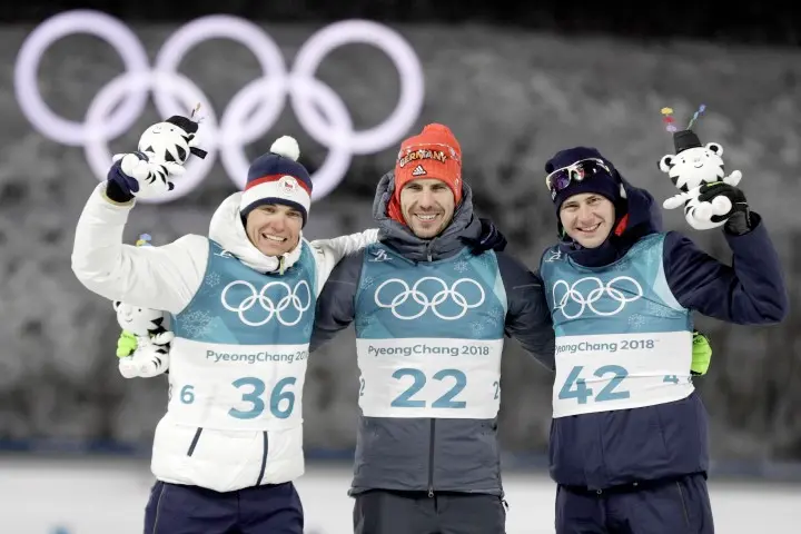 Silver medalist Michal Krcmar, of the Czech Republic, left, gold medalist Arnd Peiffer, of Germany, center and bronze medalist Dominik Windisch, of Italy, right, celebrate during the venue ceremony after the men's 10-kilometer biathlon sprint at the 2018 Winter Olympics in Pyeongchang, South Korea, Sunday, Feb. 11, 2018. (ANSA/AP Photo/Gregorio Borgia) [CopyrightNotice: Copyright 2018 The Associated Press. All rights reserved]