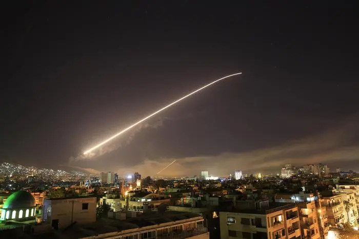 Damascus sky lights up with service to air missile fire as the U.S. launches an attack on Syria targeting different parts of the Syrian capital Damascus, Syria, early Saturday, April 14, 2018. Syria's capital has been rocked by loud explosions that lit up the sky with heavy smoke as U.S. President Donald Trump announced airstrikes in retaliation for the country's alleged use of chemical weapons. (ANSA/AP Photo/Hassan Ammar) [CopyrightNotice: Copyright 2018 The Associated Press. All rights reserved.]