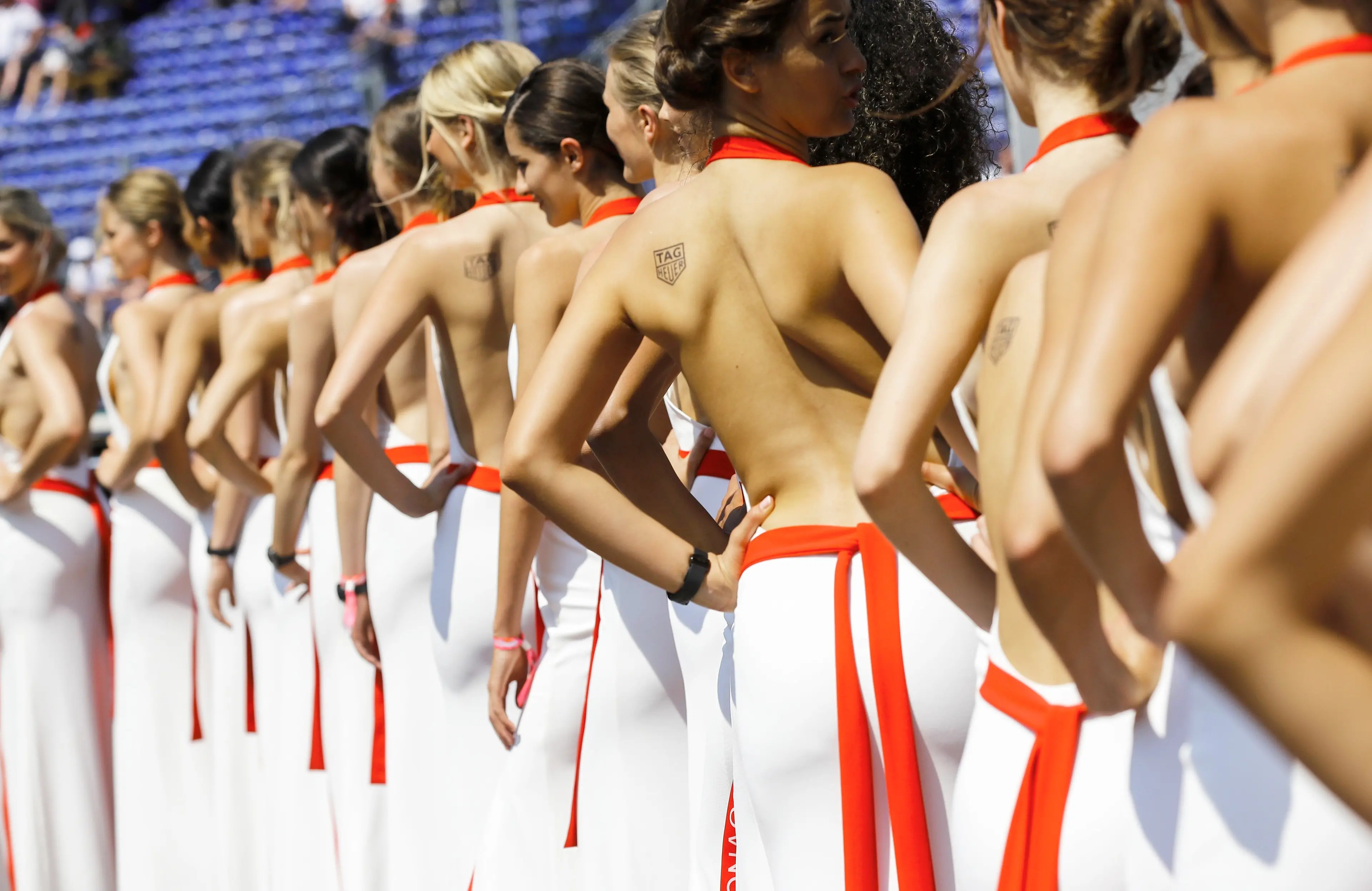 FILE - In this file photo dated Saturday, May 27, 2017, so called \\\"grid girls\\\" line up after the qualifying session for the Formula One Grand Prix at the Monaco racetrack in Monaco. Formula One says it is ending the practice of using \\\"grid girls\\\" and \\\"podium girls\\\" at races, with F1 managing director of commercial operations Sean Bratches saying Wednesday Jan. 31, 2018, the use of the women on the grid is clearly \\\"at odds with modern day societal norms.\\\" (ANSA/AP Photo/Frank Augstein, FILE) [CopyrightNotice: Copyright 2017 The Associated Press. All rights reserved.]
