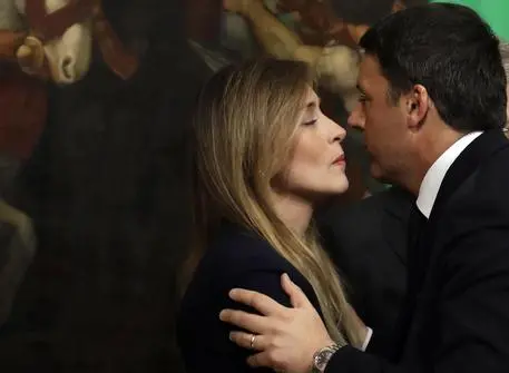 Italian outgoing Premier Matteo Renzi, right, kisses new Italian Cabinet Undersecretary Maria Elena Boschi at Chigi Palace Premier's office, in Rome, Monday, Dec. 12, 2016. Paolo Gentiloni, a Democrat serving as foreign minister, formed Italys new government Monday, keeping several key ministers from the coalition of Matteo Renzi, who resigned last week. (ANSA/AP Photo/Gregorio Borgia) [CopyrightNotice: AP]
