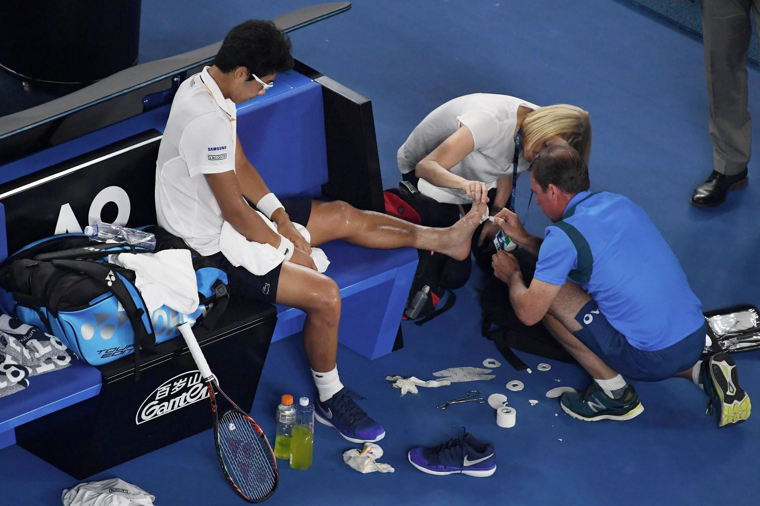 epa06475086 Hyeon Chung of South Korea receives treatment as he plays Roger Federer of Switzerland during the mens semifinal on day twelve of the Australian Open tennis tournament, in Melbourne, Australia, Friday, January 26, 2018. EPA/DEAN LEWINS