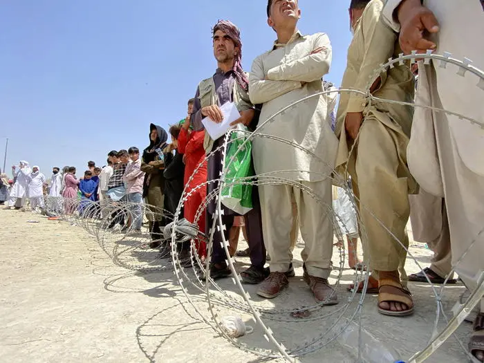 epa09417769 Afghans including those who worked for the US, NATO, Europe Union and the United Nations in Afghanistan wait outside the Hamid Karzai International Airport to flee the country, after Taliban took control of Kabul, Afghanistan, 17 August 2021. Several people were reportedly killed at Kabul airport on 16 August as Afghans were attempting to hang on a moving US military plane leaving the airport. Taliban co-founder Abdul Ghani Baradar earlier in the day declared victory and an end to the decades-long war in Afghanistan, a day after the insurgents entered Kabul to take control of the country. Baradar, who heads the Taliban political office in Qatar, released a short video message after President Ashraf Ghani fled and conceded that the insurgents had won the 20-year war. EPA/STRINGER