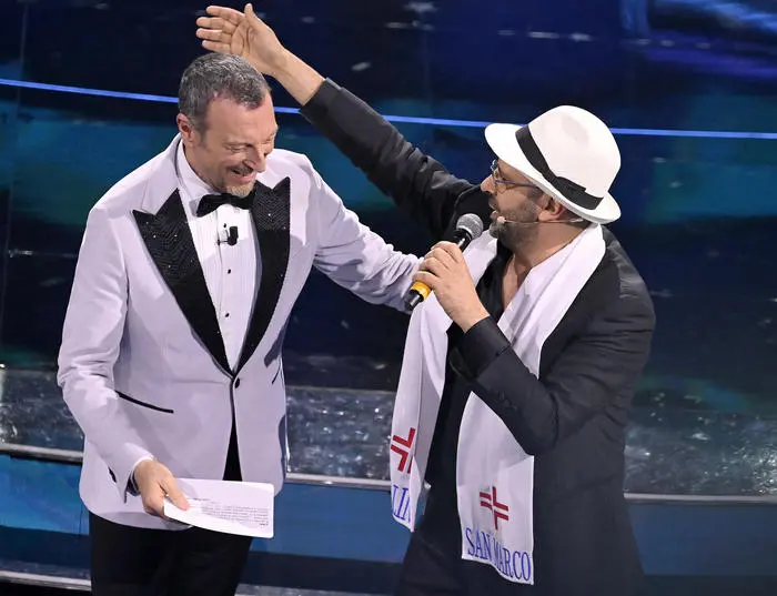 Sanremo Festival host and artistic director, Amadeus (L), and Italian actor Checco Zalone on stage at the Ariston theatre during the 72nd Sanremo Italian Song Festival, Sanremo, Italy, 02 February 2022. The music festival runs from 01 to 05 February 2022. ANSA/RICCARDO ANTIMIANI