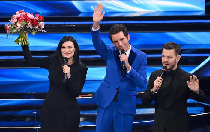 (L-R) Italian singer Laura Pausini, Lebanese-British singer Mika, and Italian Tv host Alessandro Cattelan on stage at the Ariston theatre during the 72nd Sanremo Italian Song Festival, in Sanremo, Italy, 02 February 2022. The music festival runs from 01 to 05 February 2022. ANSA/RICCARDO ANTIMIANI