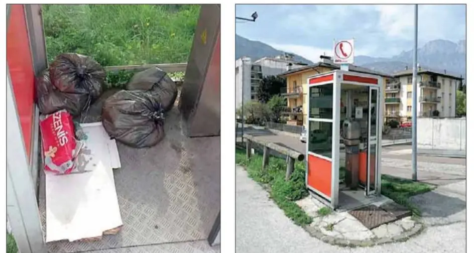 Gardolo, vecchia cabina telefonica ridotta a discarica di rifiuti