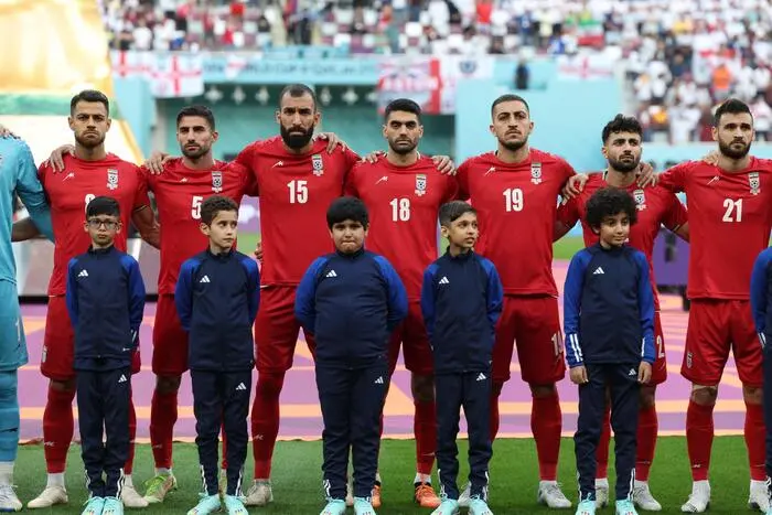 Iran players listen to the national anthem ahead of the Qatar 2022 World Cup Group B football match between England and Iran at the Khalifa International Stadium in Doha on November 21, 2022. (Photo by FADEL SENNA / AFP)
