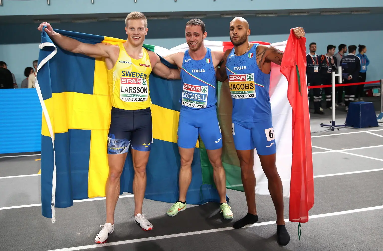 epa10503253 Winner Samuele Ceccarelli of Italy, second placed Lamont Marcell Jacobs of Italy and third placed Henrik Larsson of Sweden celebrate after the Men's 60m final at the European Athletics Indoor Championships in Istanbul, Turkey, 04 March 2023. EPA/Tolga Bozoglu