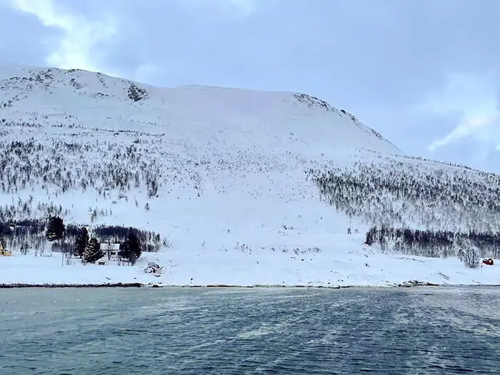 epa10552927 A handout photo made available by the Norwegian Society for Sea Rescue (Redningsselskapet, RS) 152 Bergesen d.y of the site of an avalanche on Reinoya island, northern Norway, 31 March 2023. At least four people, including a foreign tourist, were killed on 31 March after several avalanches hit Norway's far north, police said. EPA/NORWEGIAN SOCIETY FOR SEA RESCUE/RS 152 BERGESEN D.Y -- BEST QUALITY AVAILABLE -- NORWAY OUT HANDOUT EDITORIAL USE ONLY/NO SALES