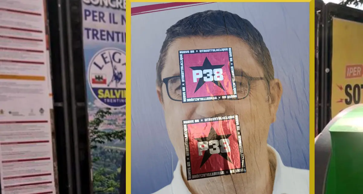 Adesivi con la stella a cinque punte e la scritta \"P38 e Br\" sui manifesti elettorali di Fugatti