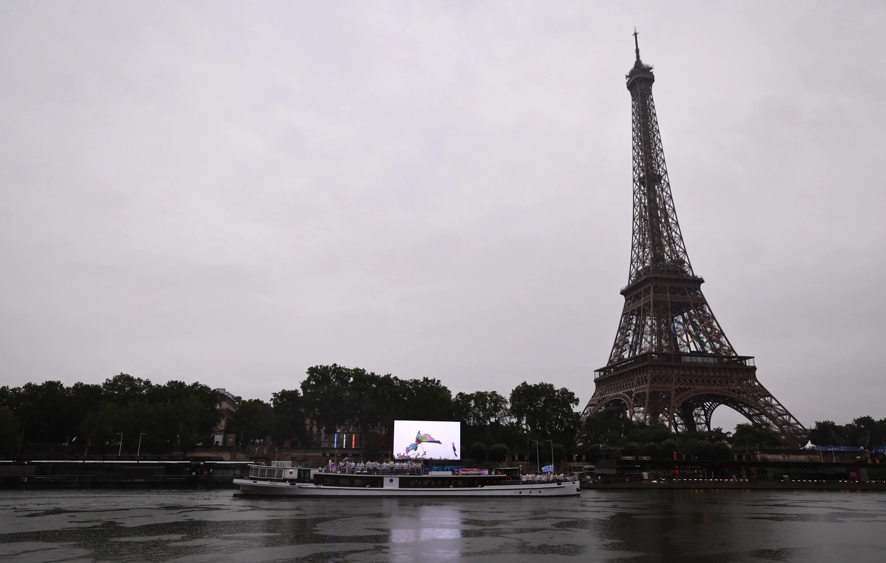 epa11497639 The boat with the Greek team passes the Eiffel Tower during the Opening Ceremony of the Paris 2024 Olympic Games, in Paris, France, 26 July 2024. EPA/ANNA SZILAGYI