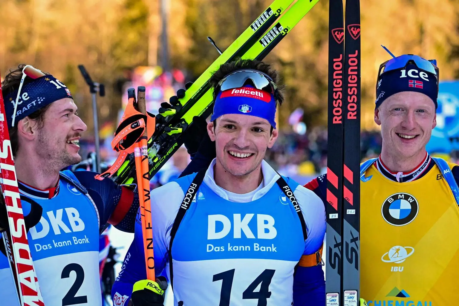 Winner, Italy's Tommaso Giacomel (C), runner up Norway's Sturla Laegreid (L) and thired placed Norway's Johannes Thingnes Bo (R) celebrate after finishing the men's 15 km mass start event of the IBU Biathlon World Cup in Ruhpolding, southern Germany on January 19, 2025. (Photo by Tobias SCHWARZ / AFP)